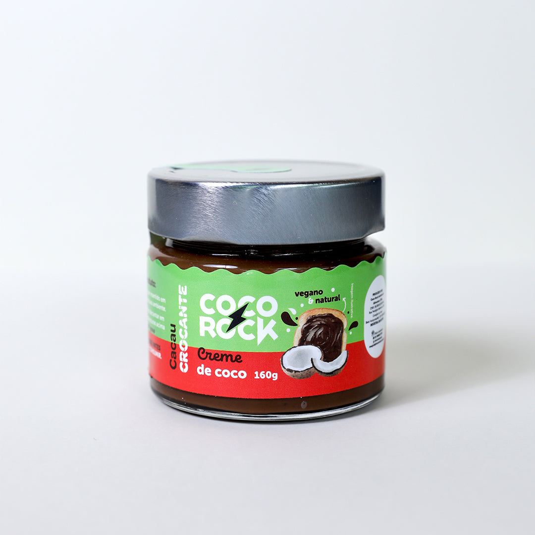 Creme de coco crocante em embalagem de 160g, com uma fatia de pão com creme em cima e dois pedaços de coco no rótulo.